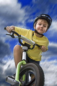 child cyclist wearing a bicycle helmet