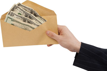 a hand proffering a cash advance envelope