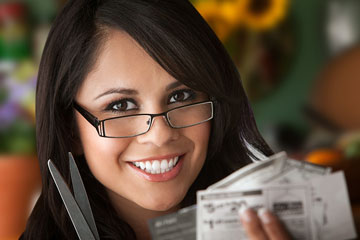 a female coupon clipper with coupons and scissors